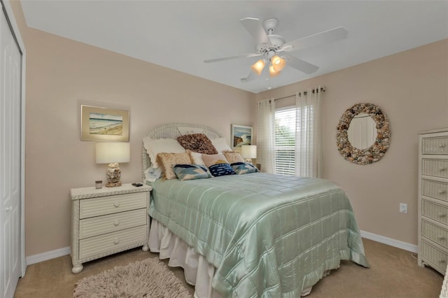 carpeted bedroom featuring a closet and ceiling fan