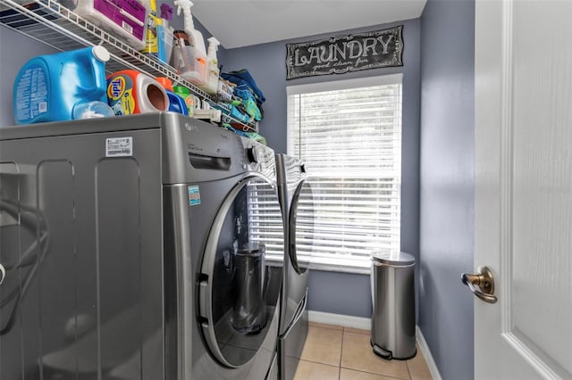 laundry area with washing machine and dryer and light tile patterned flooring