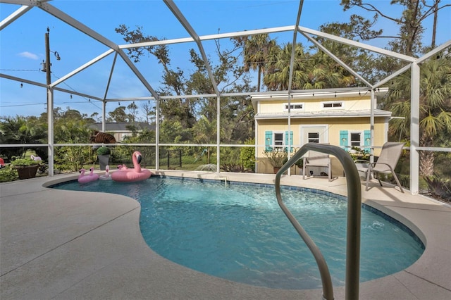 view of pool with a patio area and a lanai