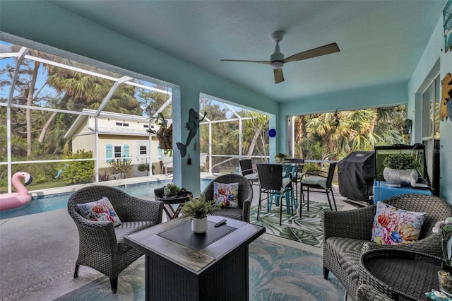 sunroom / solarium with ceiling fan and a swimming pool