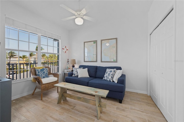 living room featuring light wood-type flooring and ceiling fan