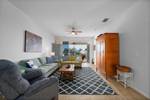 living room with ceiling fan and light hardwood / wood-style flooring