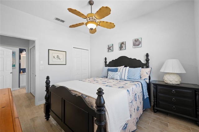 bedroom featuring ceiling fan, light hardwood / wood-style floors, and a closet