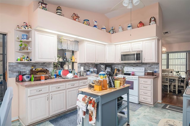 kitchen with white cabinetry, white electric range, backsplash, and high vaulted ceiling