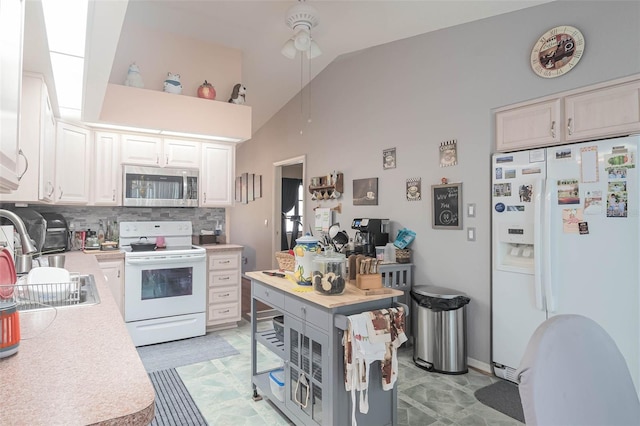 kitchen featuring white cabinetry, ceiling fan, tasteful backsplash, high vaulted ceiling, and white appliances