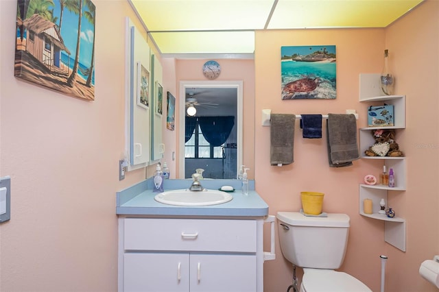 bathroom with vanity, ceiling fan, and toilet