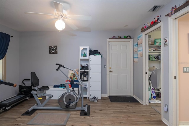 exercise room featuring hardwood / wood-style floors and ceiling fan