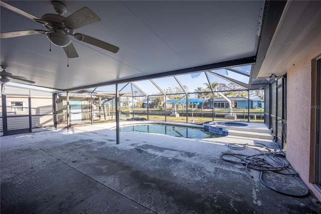 view of pool with an in ground hot tub, glass enclosure, and a patio