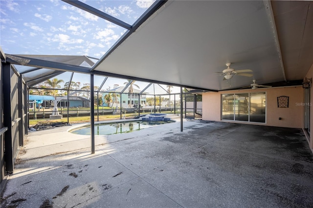 view of swimming pool featuring an in ground hot tub, ceiling fan, glass enclosure, and a patio area