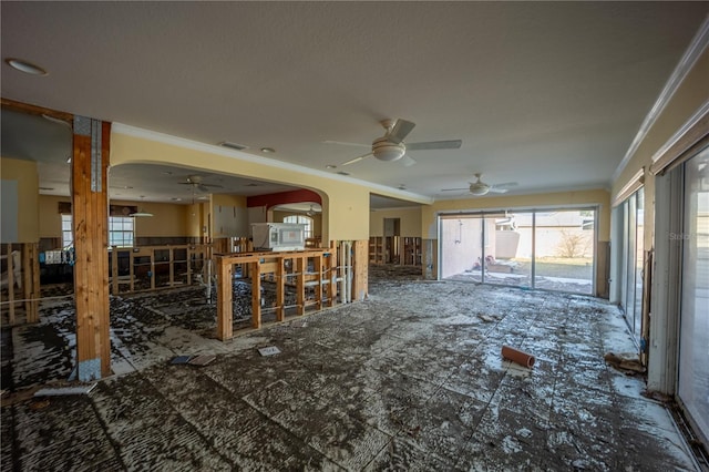 living room with crown molding and ceiling fan