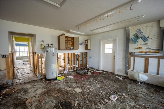 interior space with a healthy amount of sunlight and water heater