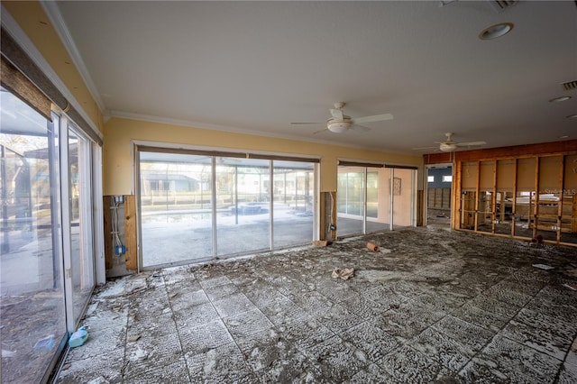 interior space with a wealth of natural light, ornamental molding, and ceiling fan