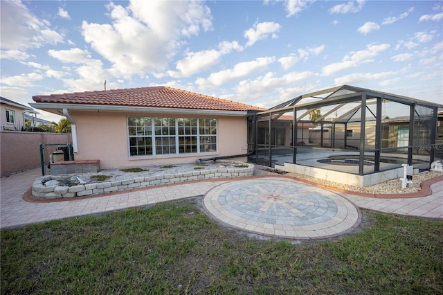 rear view of house with a fenced in pool, a patio, a lanai, and a yard