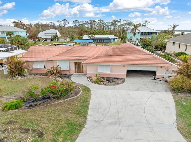 single story home with a residential view, a tile roof, driveway, a garage, and stucco siding