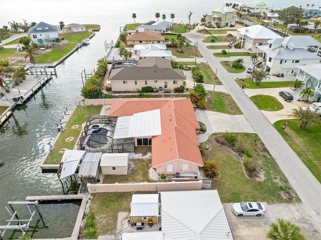 birds eye view of property with a water view and a residential view