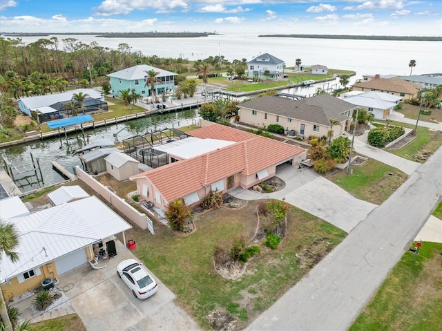 drone / aerial view with a water view and a residential view