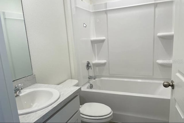 full bathroom featuring bathing tub / shower combination, vanity, and toilet