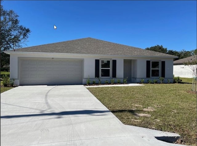 single story home featuring a garage and a front yard