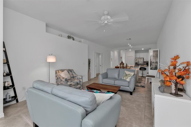 tiled living room with ceiling fan