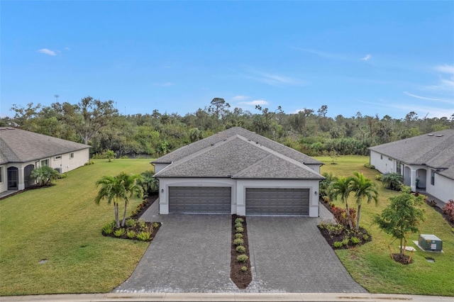 view of front of property with a front lawn and a garage