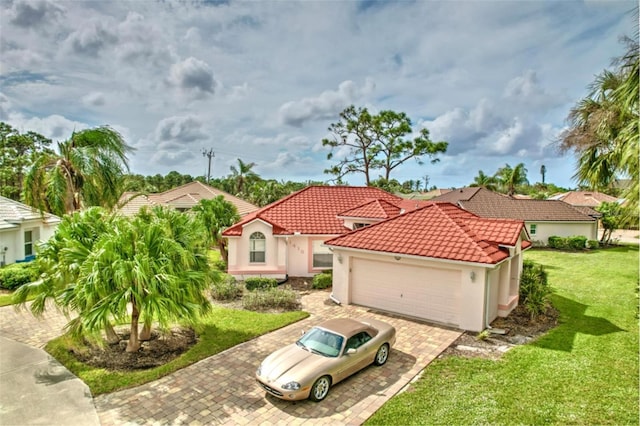 mediterranean / spanish-style house with a front yard and a garage