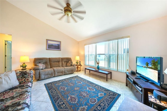 living room with ceiling fan, light tile patterned floors, and vaulted ceiling