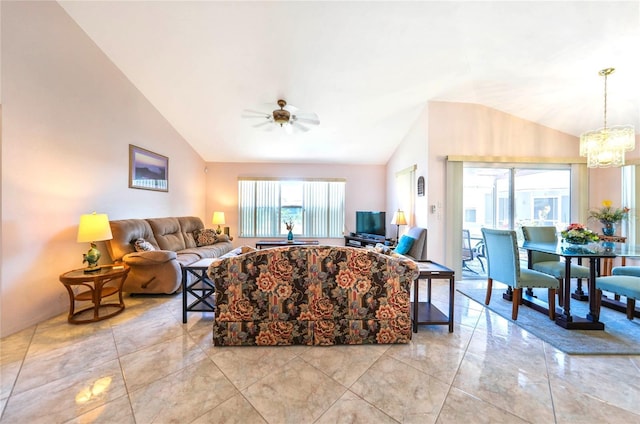 living room featuring vaulted ceiling and ceiling fan with notable chandelier