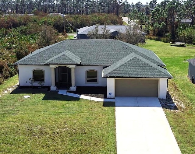 view of front of property with a garage and a front lawn