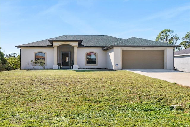 view of front of property with a front yard and a garage