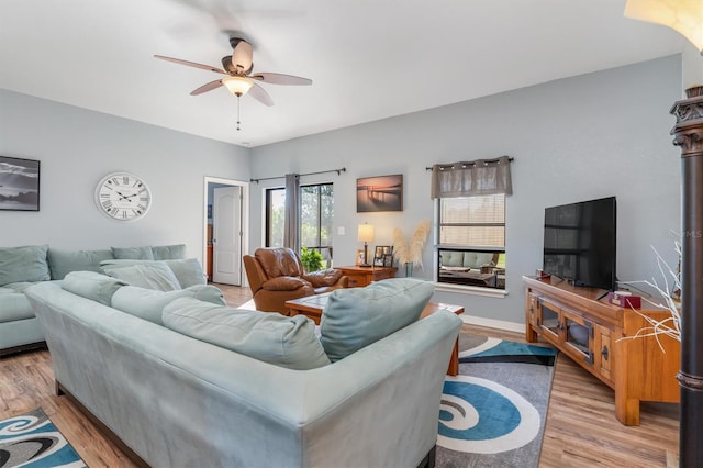 living room featuring ceiling fan and light hardwood / wood-style floors