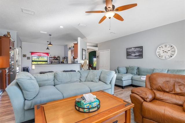 living room with light wood-type flooring and ceiling fan