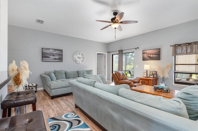 living room featuring ceiling fan and light hardwood / wood-style floors