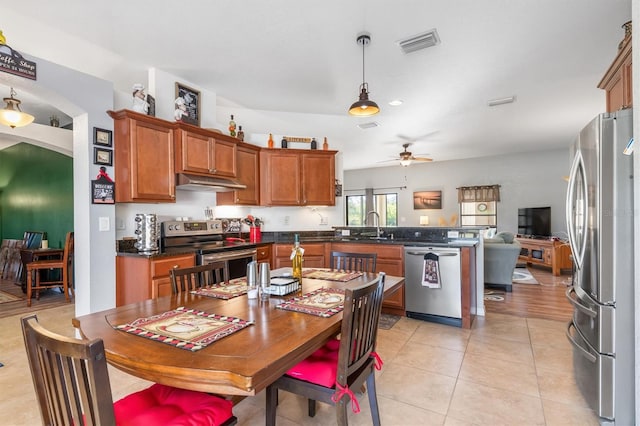 kitchen featuring sink, hanging light fixtures, ceiling fan, appliances with stainless steel finishes, and light tile patterned flooring