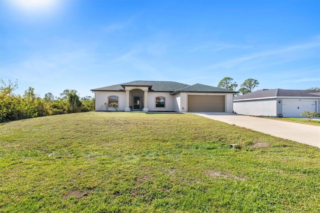 view of front of home with a front yard and a garage