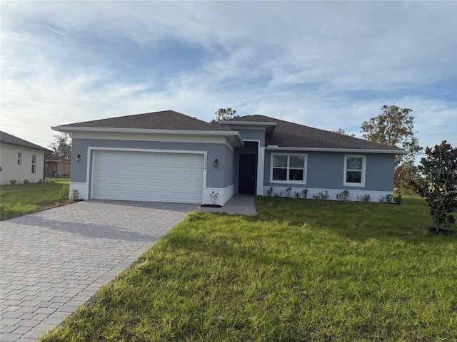 ranch-style home featuring a front lawn and a garage