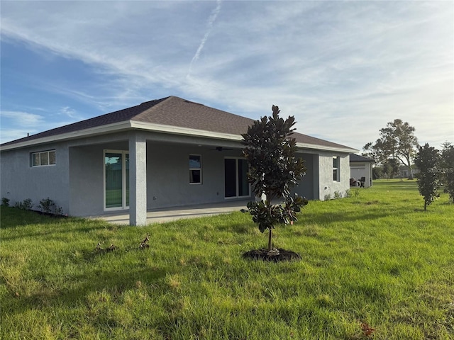 rear view of house featuring a lawn and a patio area