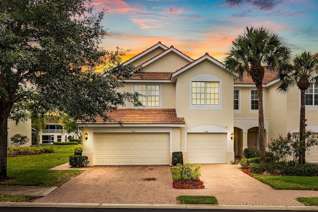 view of front of property with a yard and a garage