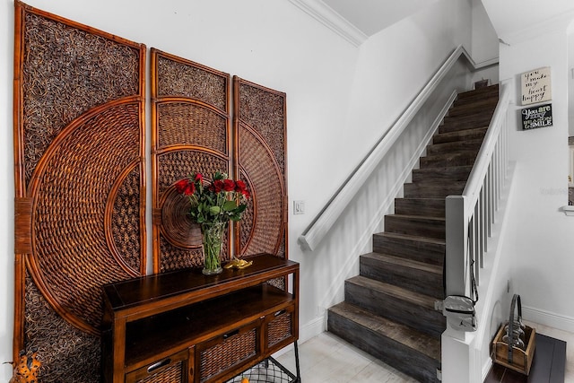 stairway featuring tile patterned floors and crown molding