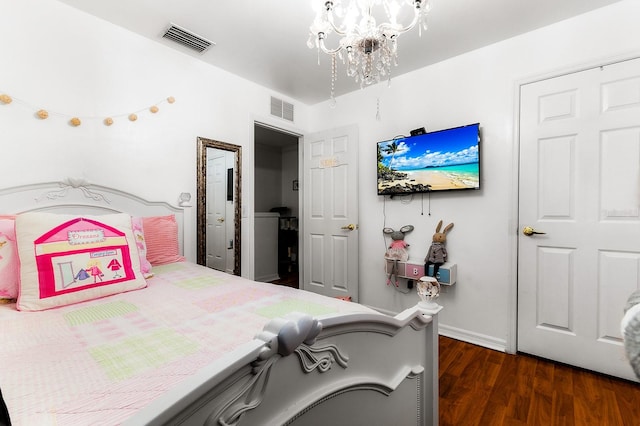 bedroom featuring a chandelier and dark wood-type flooring