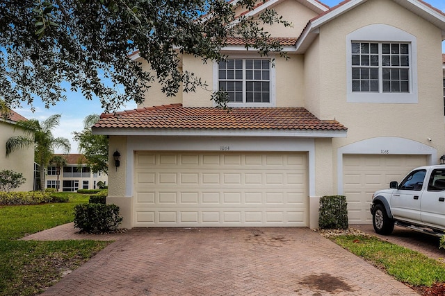 mediterranean / spanish-style home featuring a garage