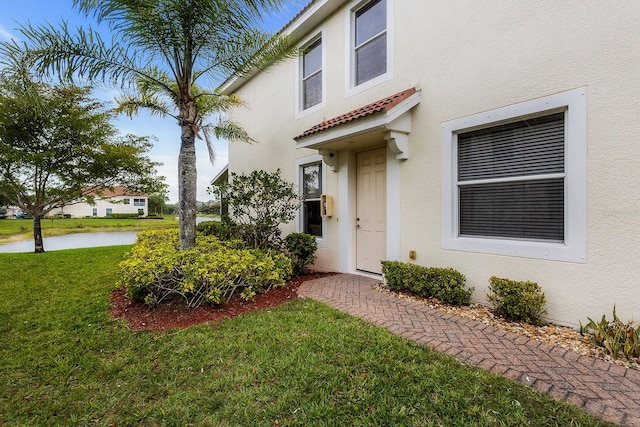 property entrance with a yard