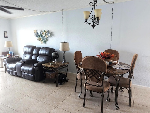 dining space with a textured ceiling, ceiling fan with notable chandelier, light tile patterned floors, and crown molding