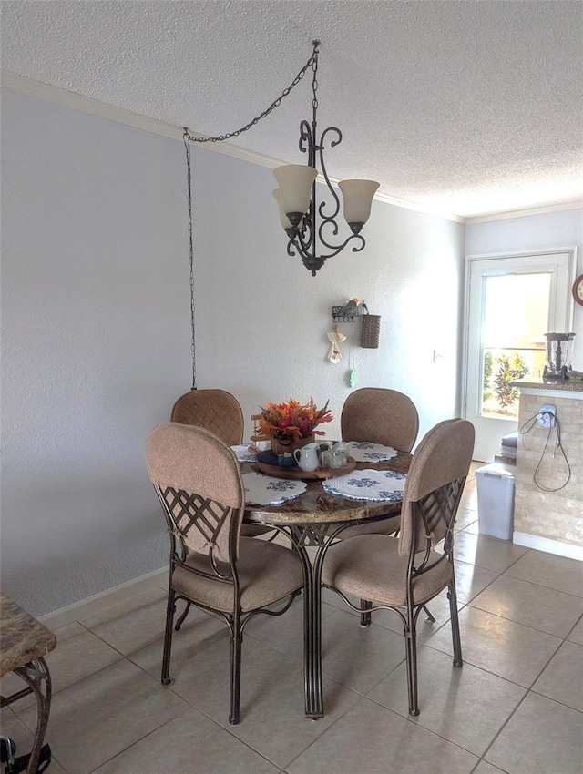 tiled dining area featuring a textured ceiling and ornamental molding