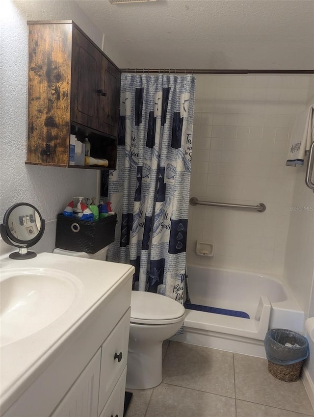 full bathroom featuring tile patterned floors, vanity, shower / bathtub combination with curtain, and a textured ceiling