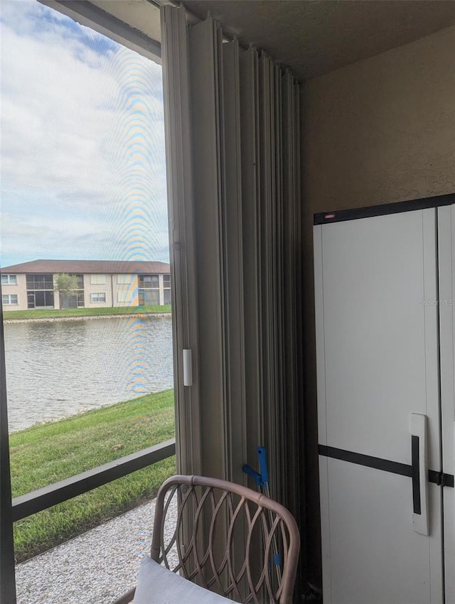 interior space featuring a water view and white fridge