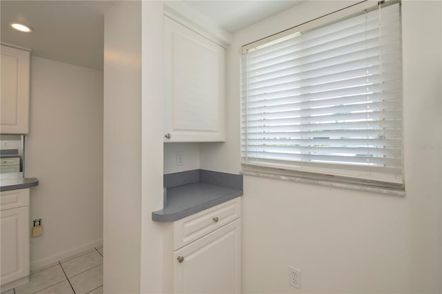 kitchen with white cabinetry and light tile patterned floors