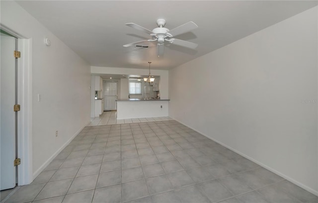 unfurnished living room featuring ceiling fan with notable chandelier and light tile patterned flooring