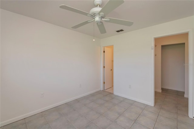 unfurnished room with ceiling fan and light tile patterned flooring