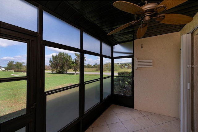 unfurnished sunroom with ceiling fan