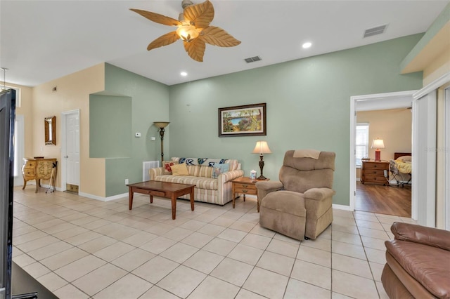 living room with ceiling fan and light tile patterned floors